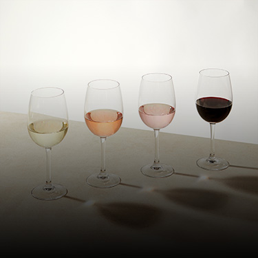 4 different glasses of wine varietals against a beige background
